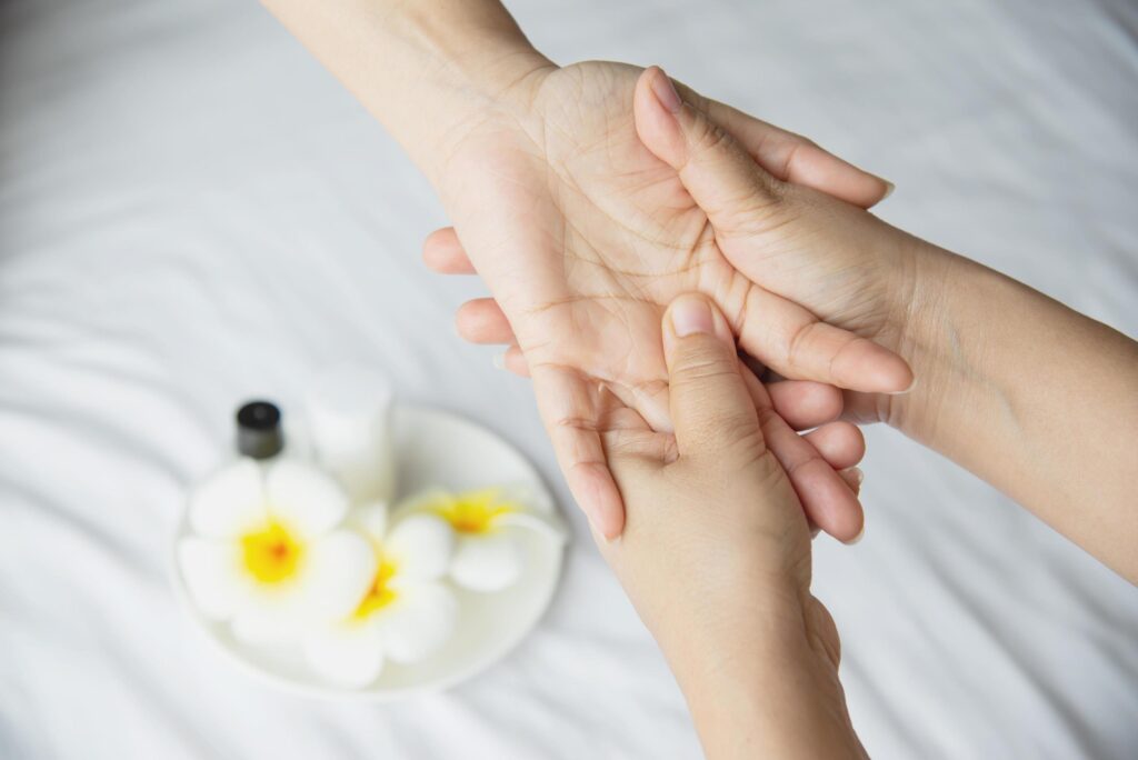 hand spa massage over clean white bed background people relax with hand massage service free photo
